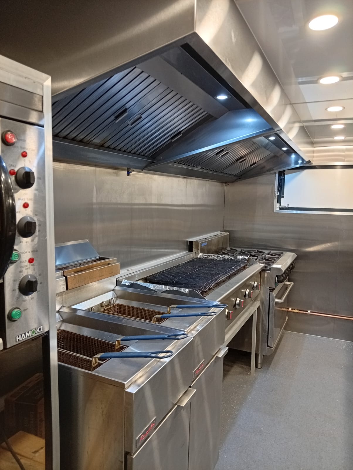 Commercial oven installation and stainless steel lining in the catering trailer