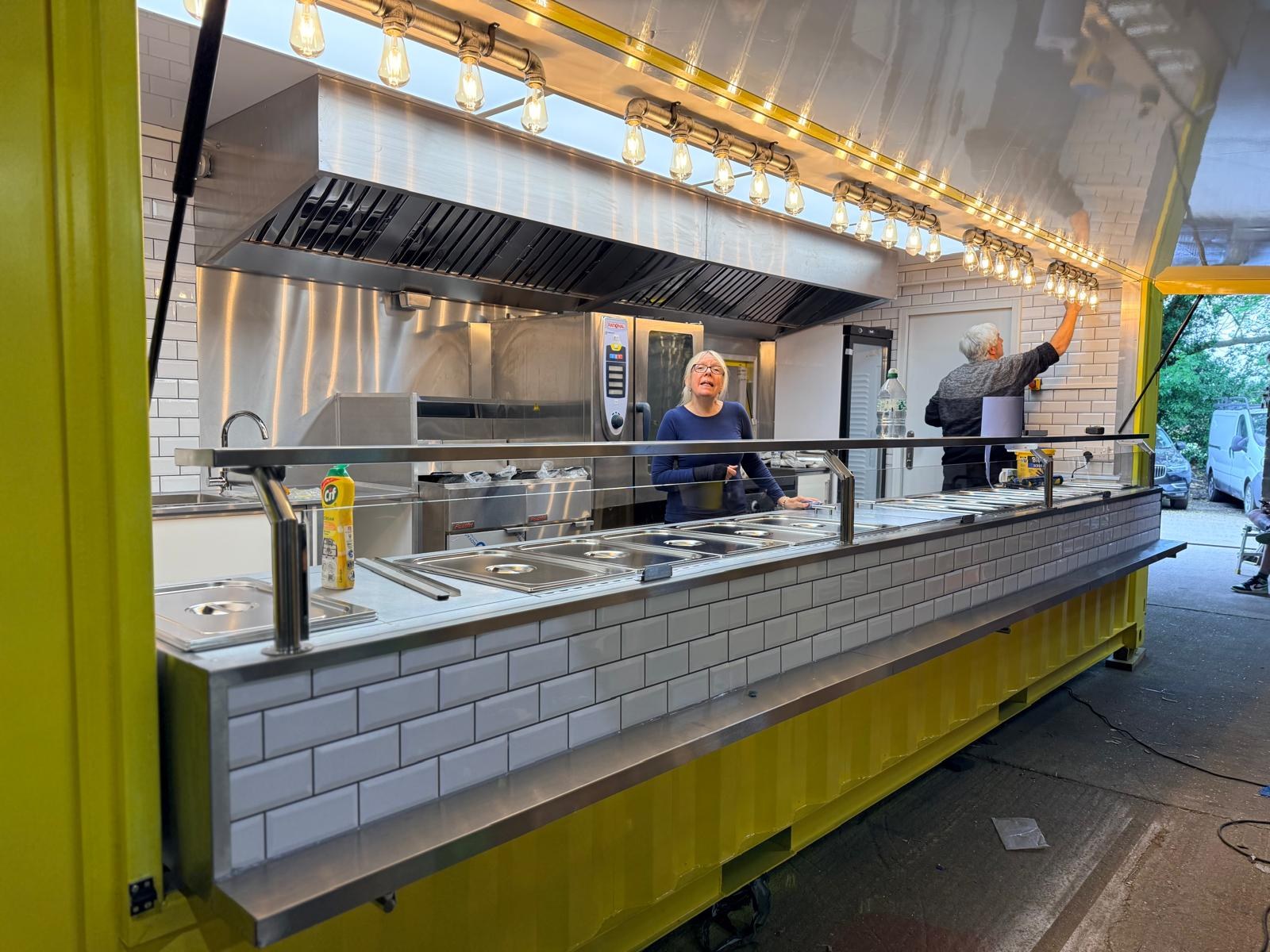 Yellow catering container with stainless steel counters and extraction