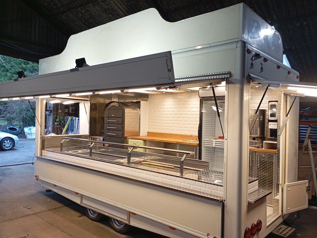 Bespoke showman style catering trailer with stainless steel and glass serving counter