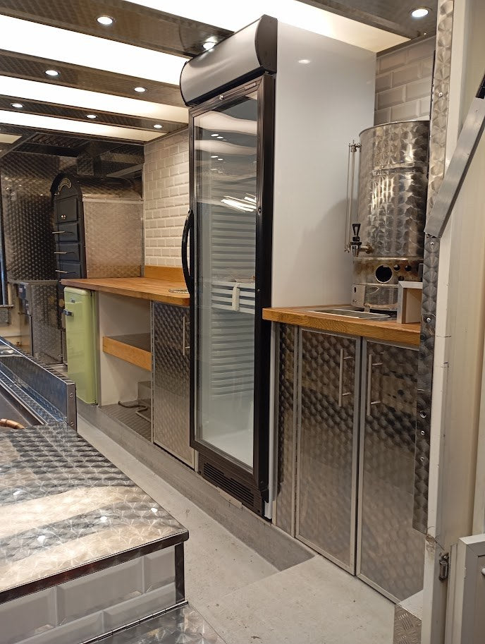 Catering trailer working area with oak worktops and stainless steel storage