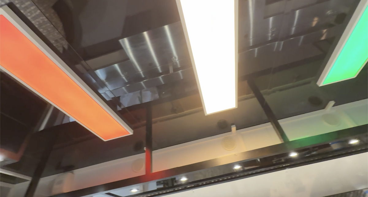 Close-up of a modern ceiling with reflective surfaces and colorful lights.