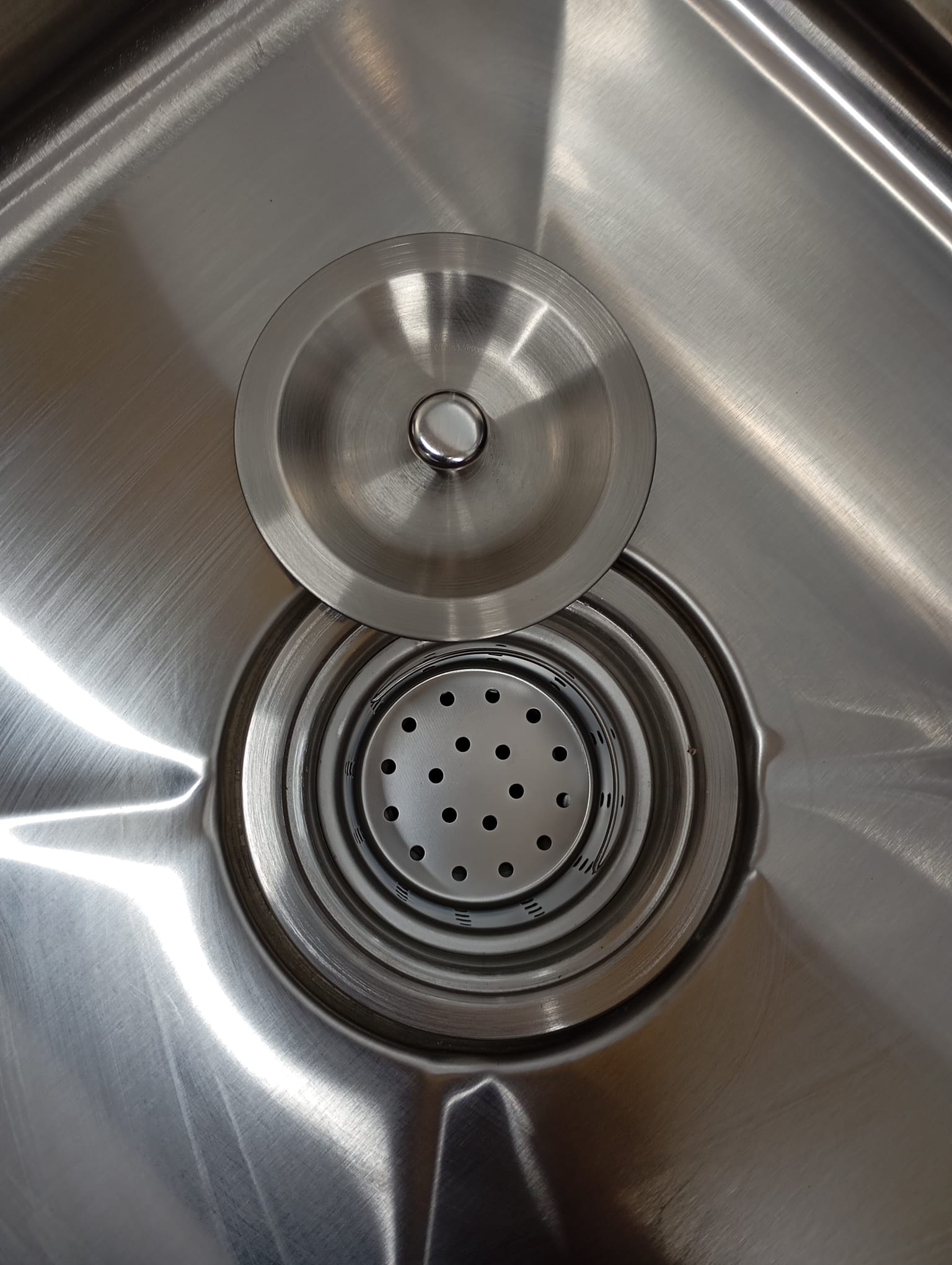 Stainless steel sink with drain and strainer